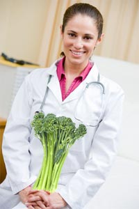 Doctor Holding Broccoli in Office